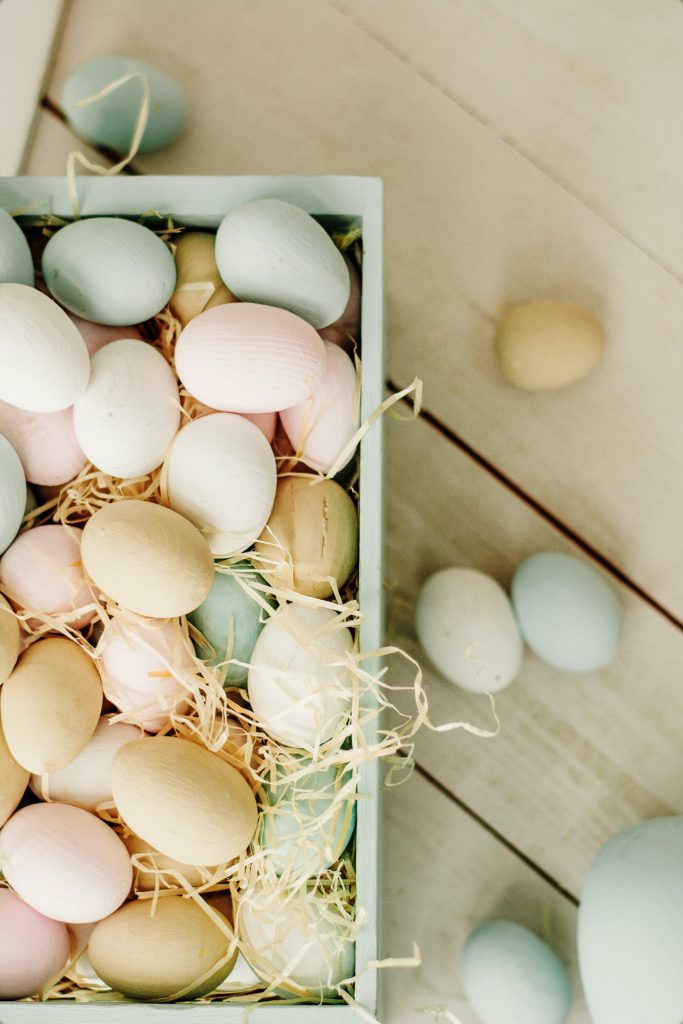 A basket of pastel colored eggs