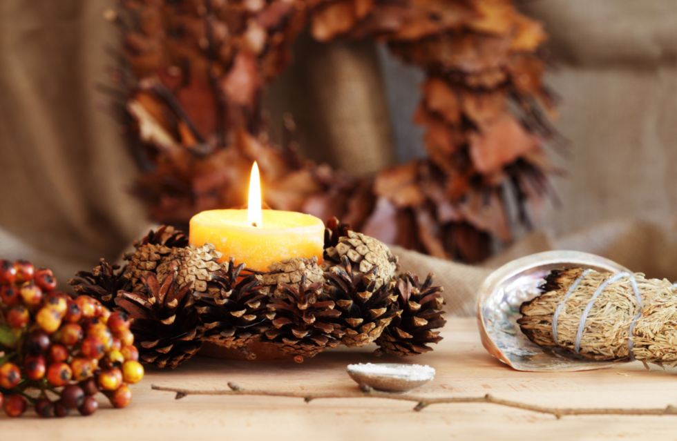 Pinecones and candles for fall on a Samhain altar.